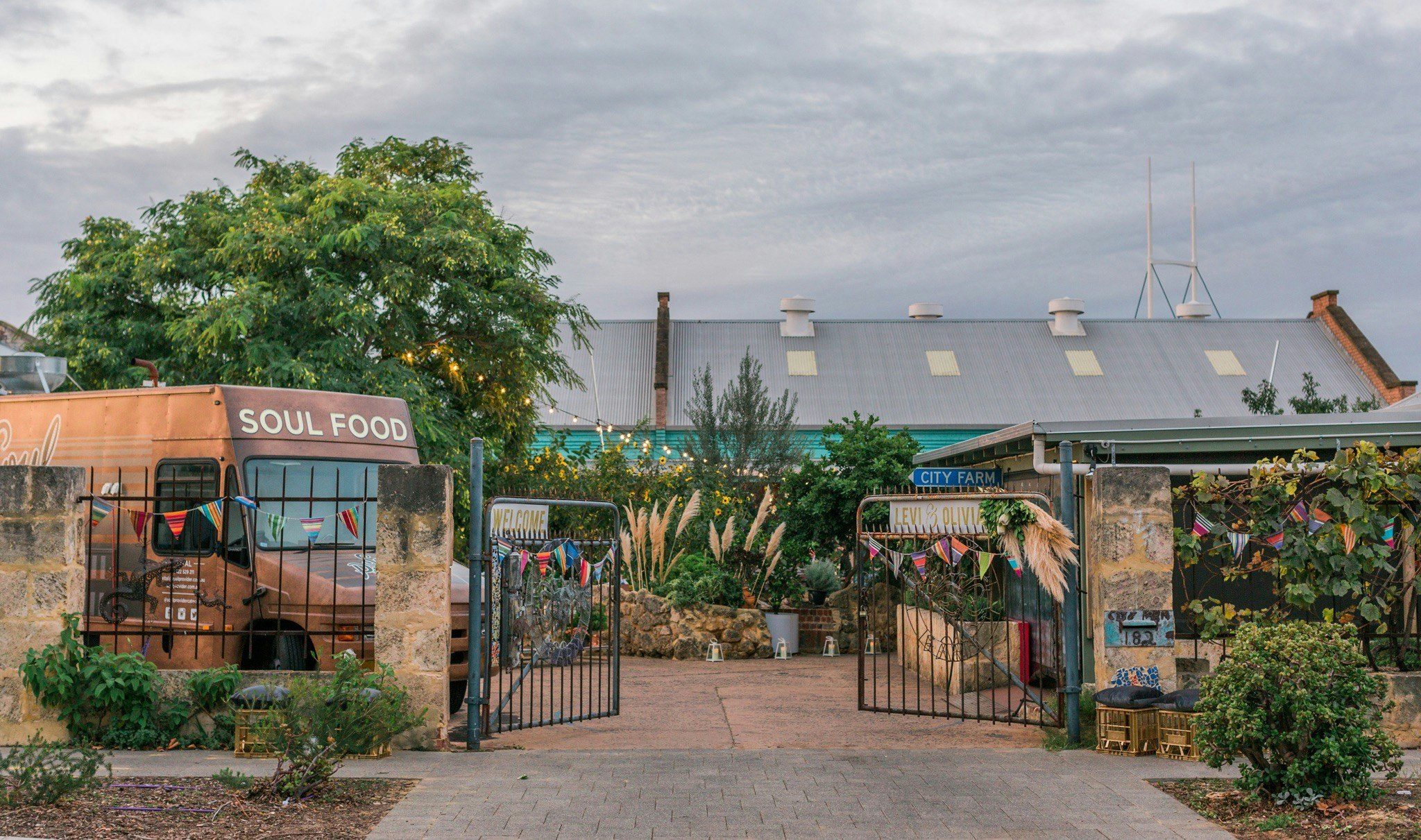 Entrance to Perth City Farm, gates open with food truck parked in garden.